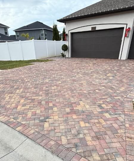 A paver driveway in front of a garage.